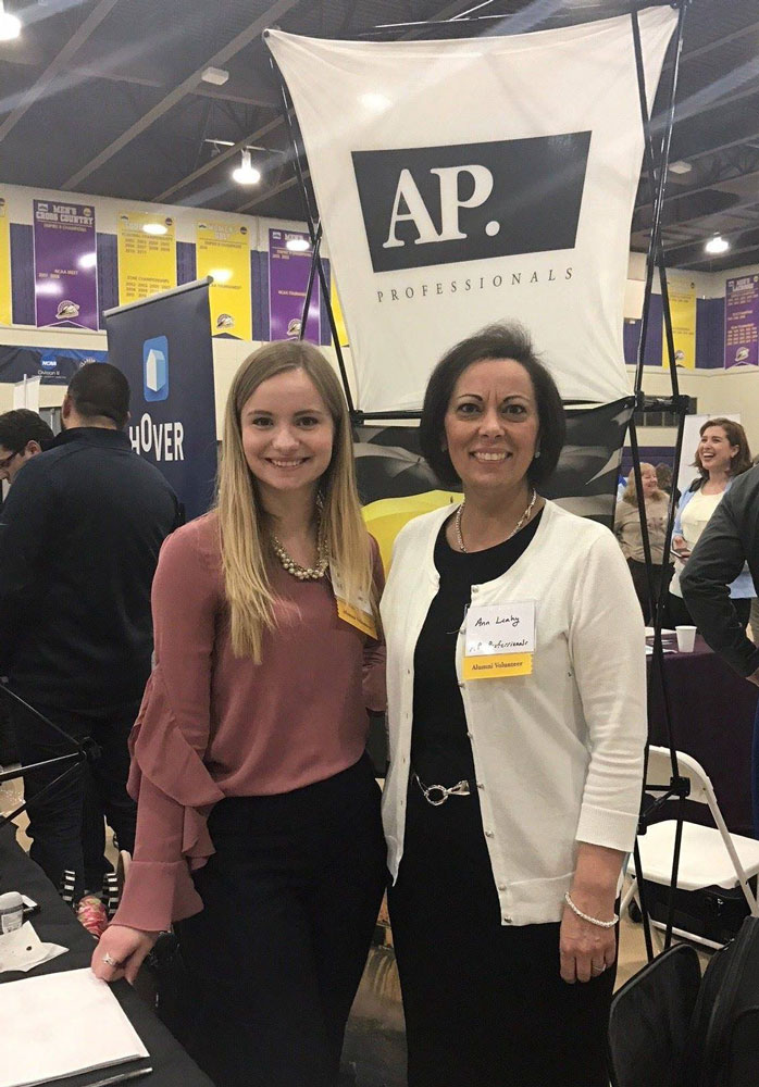 Two AP professional employees pose for a photo at the Nazareth College job fair