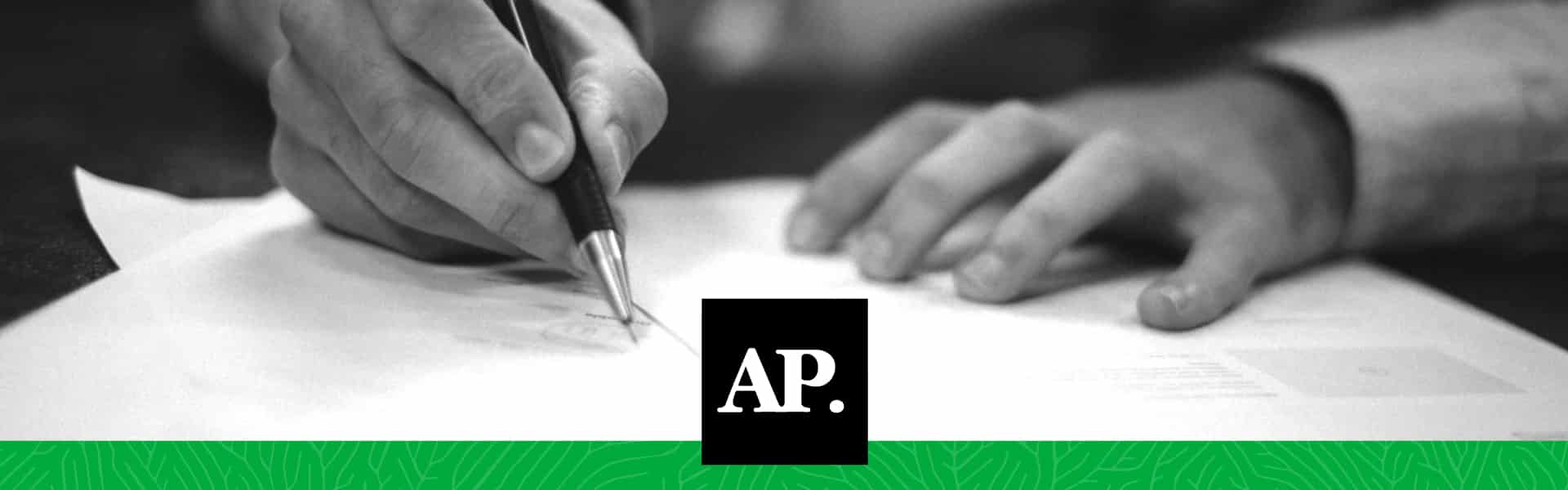 AP logo with person signing a piece of paper.